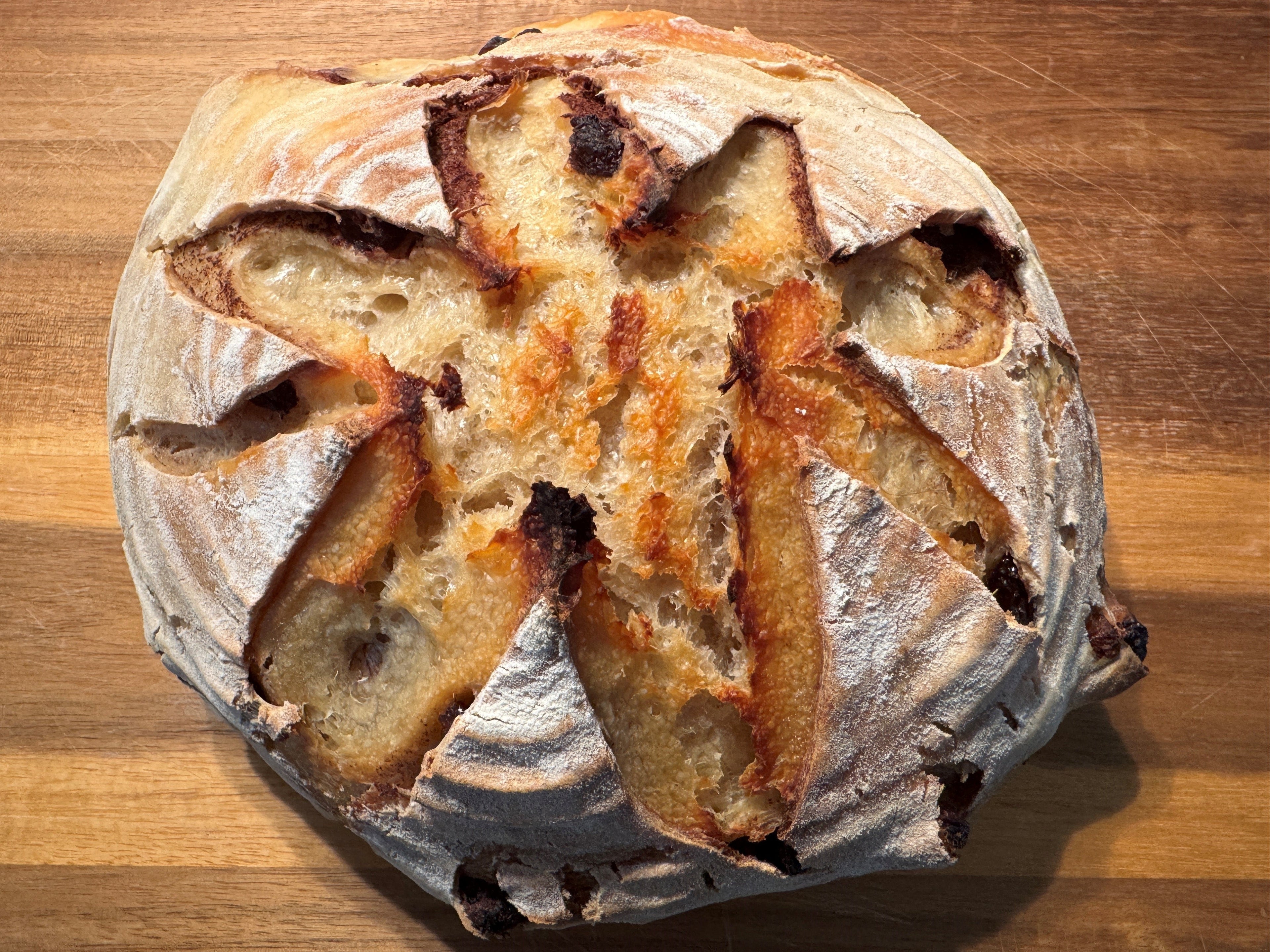 Loaf of bread with a star-shaped cutout on a wooden surface